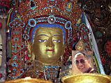 
The Chapel of Jowo Shakyamuni is the most important shrine in Tibet, housing a 1.5m sitting image of Shakyamuni at the age of 12. It is supposedly one of only three made during his lifetime. It was a gift from the Chinese Princess Wencheng to her husband King Songtsen Gampo. The Jowo sits on a majestic massive three-tiered stone platform. Two silver-plated dragons presented by the Chinese emperor entwine the ornate pillars that support an intricate double canopy over the Jowo. An ornate crown of coral, turquoise, diamonds, rubies, and other precious gems, sits on the Jowo’s head. Although there’s no photography allowed, here’s a photo from my 1993 trip. Note the photo of the current Dalai Lama, allowed in 1993 in a period of religious tolerance.
